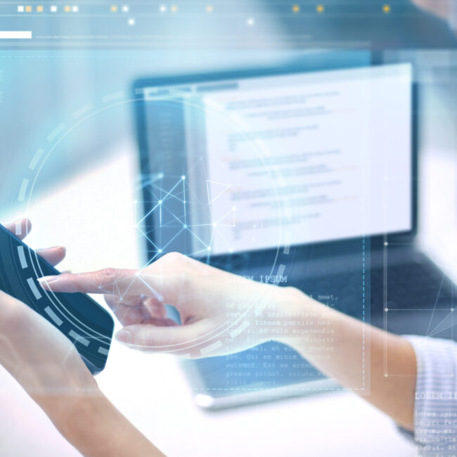 business, technology and people concept - close up of businesswoman with laptop computer and smartphone at office